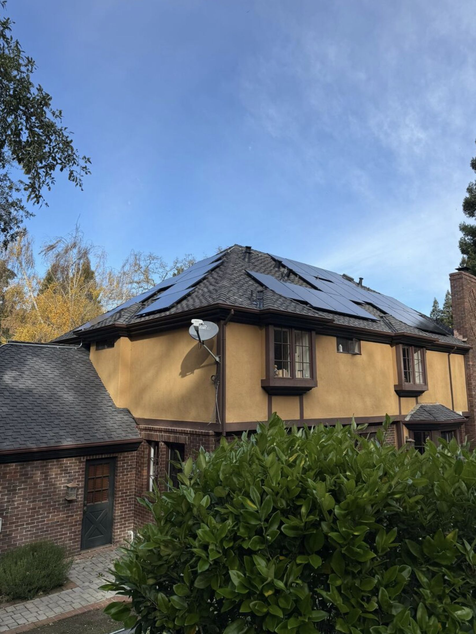 Character home solar installation — brick and stucco, mature trees